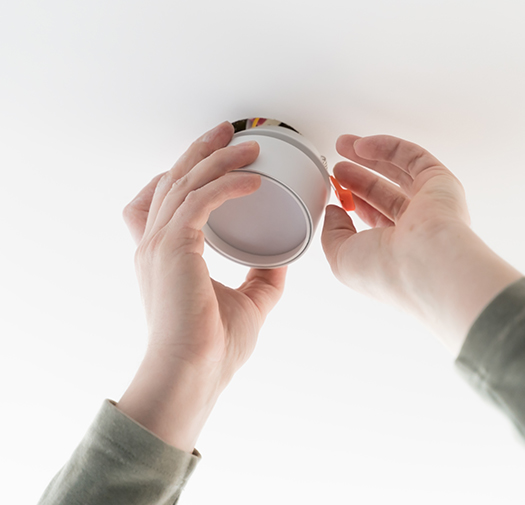 Technician testing smoke and CO2 detector batteries during professional home safety service in Chester County by BB Dryer Vents